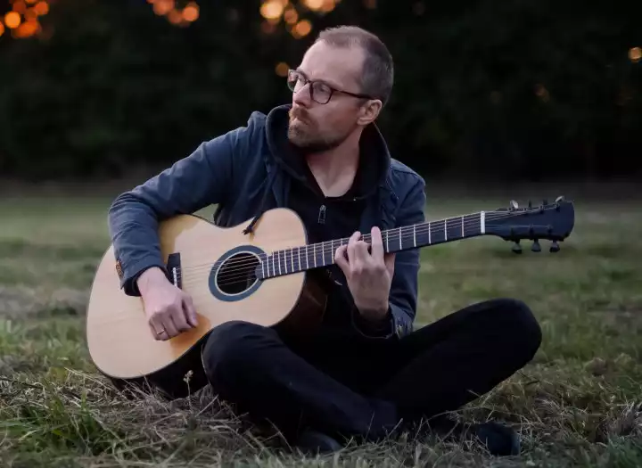I will arrange and record professional acoustic open-tunning guitar for your music